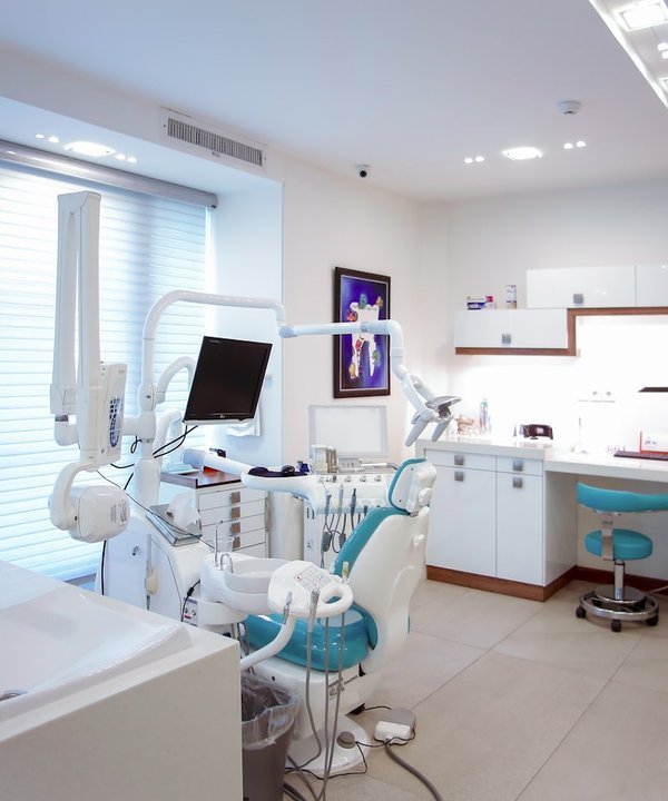 Bright modern Ottawa dental operatory with chair, lighting, and digital monitor